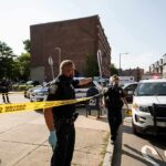 Street Mayhem: NYPD Officer Run Down Police officers secure an urban street with yellow tape near patrol cars