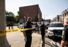Street Mayhem: NYPD Officer Run Down Police officers secure an urban street with yellow tape near patrol cars