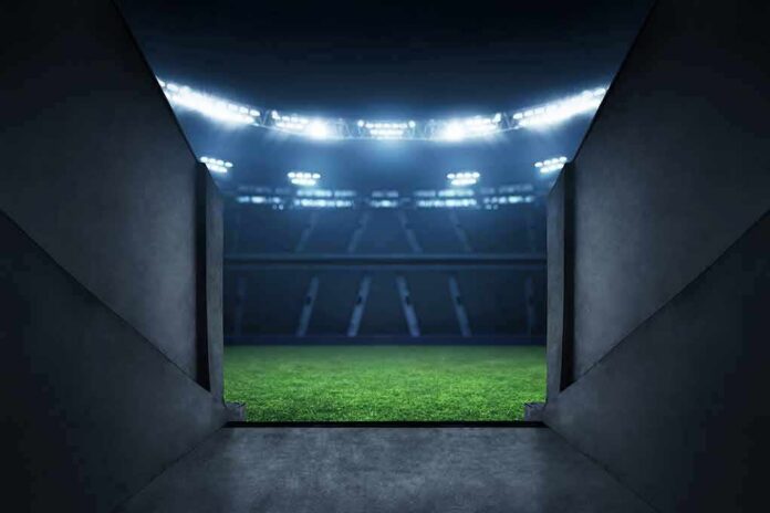 Stadium tunnel opening onto a brightly lit field