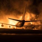 Chilling Houthi Ultimatum Targets Airports Airplane on runway with large fire and smoke at night