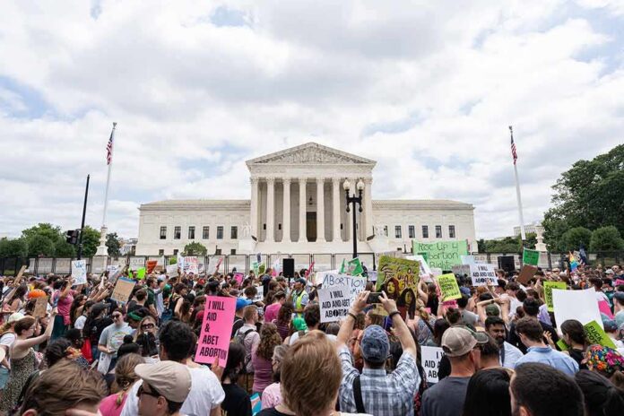 Dontrelle Inman and Walter Jones amid a large protest crowd outside a neoclassical courthouse