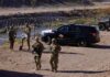 Pentagon Laser TORCHES Cartel Drones Soldiers stand near barbed wire beside a police SUV