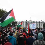 Mass Yemen Uprising Rattles Saudi Grip Crowd holding flags and signs outside a fenced government building