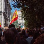 Housing Revolt Forces Snap Election Crowd with Spanish flags in a city street