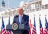 Trump’s Slur Ignites South Carolina Brawl Donald Trump speaking at a podium with American flags and a ship in the background