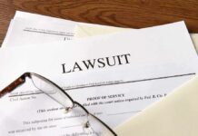 Kristi Noem Divorcing Cross-Dressing Hubby Legal documents labeled lawsuit on a desk