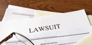 Kristi Noem Divorcing Cross-Dressing Hubby Legal documents labeled lawsuit on a desk