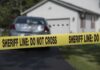 Retired Police Couple Found Dead With Daughter Sheriff line tape blocking a suburban driveway