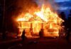 house engulfed in flames at night