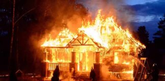 house engulfed in flames at night