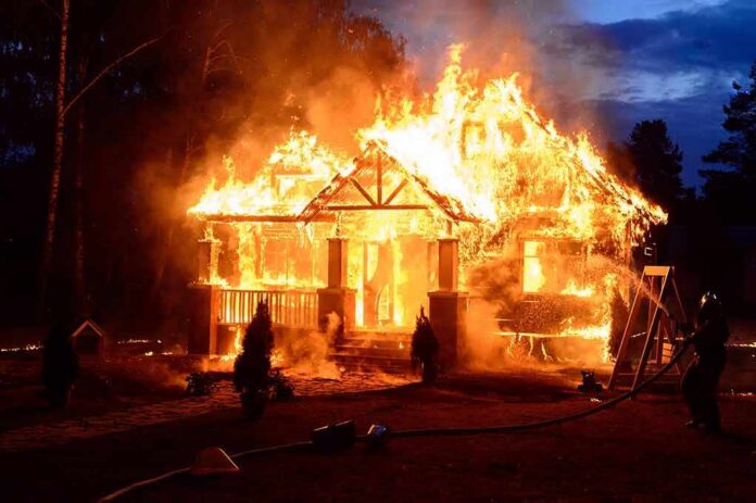 shutterstock_569622439 house engulfed in flames at night