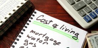 Sticker Shock Hits Weeks Before Voting Budget notebook with cost of living list, calculator, and cash