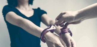 Houston Custody Clash Ends In Blood Person being handcuffed with hands extended forward