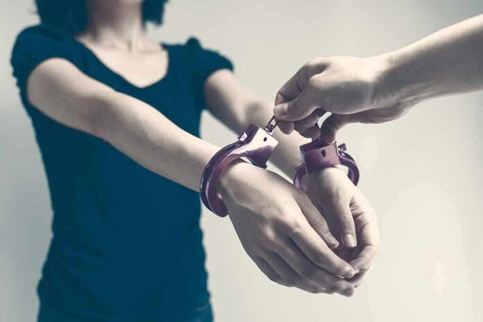 shutterstock_642247138 Person being handcuffed with hands extended forward