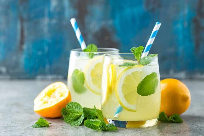 shutterstock_662695249 Two glasses of lemonade with lemon slices and mint