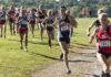 Courtney Bruce and Adelina Sotnikova running in a cross-country race with a large pack